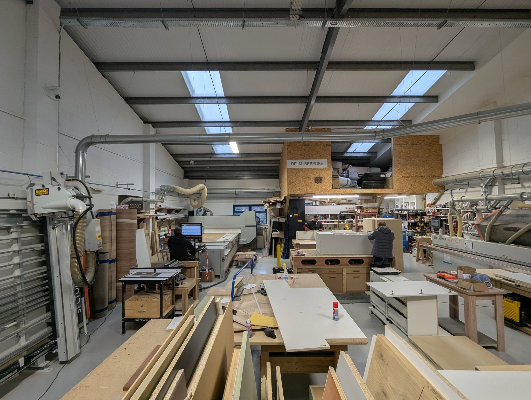 Furniture workshop interior — CNC, panel saw and edgebander